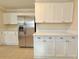 Bright kitchen with modern stainless steel fridge and white cabinets and countertops at 2437 N Decatur Rd, Decatur, GA 30033
