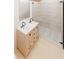 Bright bathroom featuring double sinks in a wood vanity and a glass-enclosed shower with stylish tile at 458 Shannon Sw Dr, Atlanta, GA 30310
