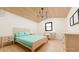 Light-filled bedroom with vaulted ceiling, a wooden bed frame and ample desk space at 458 Shannon Sw Dr, Atlanta, GA 30310