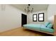 Light-filled bedroom with a modern chandelier, hardwood floors, and sleek black closet doors at 458 Shannon Sw Dr, Atlanta, GA 30310