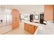 Modern kitchen open to the living area with light wood cabinetry and stainless steel appliances at 458 Shannon Sw Dr, Atlanta, GA 30310