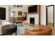 Bright living room featuring a fireplace, modern furniture, and an open layout to the kitchen and dining area at 458 Shannon Sw Dr, Atlanta, GA 30310