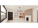 Bright living room showcasing large windows, modern chandelier, and an open connection to the kitchen at 458 Shannon Sw Dr, Atlanta, GA 30310