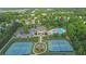 Aerial view of neighborhood amenities including a pool, clubhouse, tennis courts, playground, and parking at 5040 Stonehaven Vw, Cumming, GA 30040