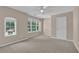Bright bedroom featuring neutral walls, carpet, a double window, and a door at 5040 Stonehaven Vw, Cumming, GA 30040
