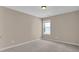This is a bright carpeted bedroom with neutral walls, a window, and recessed lighting at 5040 Stonehaven Vw, Cumming, GA 30040