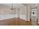 Traditional dining room with wainscoting, hardwood floors, chandelier, and views to the backyard at 5040 Stonehaven Vw, Cumming, GA 30040
