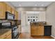 Cozy kitchen with stainless steel appliances, granite countertops, and view to the living area at 5040 Stonehaven Vw, Cumming, GA 30040