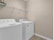 Dedicated laundry room with washer, dryer, and storage shelf at 5040 Stonehaven Vw, Cumming, GA 30040