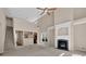 Open living room with a fireplace, lots of natural light, and view of kitchen and staircase at 5040 Stonehaven Vw, Cumming, GA 30040