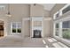 Open-concept living room with fireplace, lots of natural light, and soaring ceilings at 5040 Stonehaven Vw, Cumming, GA 30040
