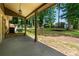 Covered patio overlooking a spacious backyard with mature trees and play equipment at 919 Rock Oak Ln, Lawrenceville, GA 30046