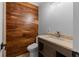 Modern bathroom with a wood-look accent wall and stylish vanity at 919 Rock Oak Ln, Lawrenceville, GA 30046