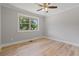 Bedroom with wood-look flooring and a large window at 919 Rock Oak Ln, Lawrenceville, GA 30046