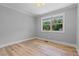 Bedroom with a window and wood-look flooring at 919 Rock Oak Ln, Lawrenceville, GA 30046