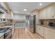 Modern kitchen with stainless steel appliances, granite countertops, and custom cabinetry at 919 Rock Oak Ln, Lawrenceville, GA 30046