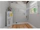 A utility room featuring a water heater and storage space at 919 Rock Oak Ln, Lawrenceville, GA 30046