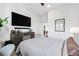 Bright bedroom features a large flat screen TV, dresser, and comfortable bed at 112 Rogers Street Ne # 410, Atlanta, GA 30317