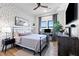 Cozy bedroom featuring unique accent wall, a modern bed frame, and streaming television at 112 Rogers Street Ne # 410, Atlanta, GA 30317
