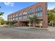 Exterior of Pullman Flats with brick facade, arched windows, and convenient covered parking on a street-level view at 112 Rogers Street Ne # 410, Atlanta, GA 30317