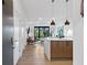 Modern kitchen featuring stainless steel appliances, wood cabinets, and stylish pendant lighting, seamlessly flowing into the living area at 112 Rogers Street Ne # 410, Atlanta, GA 30317