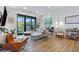 Bright and inviting living space with modern furnishings, wood floors, and balcony access with views of the surrounding greenery at 112 Rogers Street Ne # 410, Atlanta, GA 30317