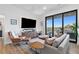 Living room featuring balcony, natural light, and stylish furnishings at 112 Rogers Street Ne # 410, Atlanta, GA 30317