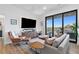 Open living space with balcony access, a large television, contemporary furnishings, and ample natural light at 112 Rogers Street Ne # 410, Atlanta, GA 30317