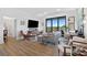 Spacious living area with wood floors, comfortable seating, a large television, balcony, and a dedicated workspace at 112 Rogers Street Ne # 410, Atlanta, GA 30317