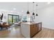 Bright, open living space with stylish pendant lighting over quartz kitchen island at 112 Rogers Street Ne # 410, Atlanta, GA 30317