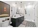 Modern bathroom with double sinks, walk-in shower, and patterned tile flooring at 112 Rogers Street Northeast Ne St # 410, Atlanta, GA 30317