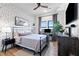 Charming bedroom with iron frame bed, black dresser, desk, and wall art at 112 Rogers Street Northeast Ne St # 410, Atlanta, GA 30317