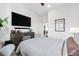 Bright bedroom featuring a large television, gray dresser, and stylish decor at 112 Rogers Street Northeast Ne St # 410, Atlanta, GA 30317