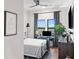 Comfortable bedroom with desk, TV, and natural light streaming through the window at 112 Rogers Street Northeast Ne St # 410, Atlanta, GA 30317