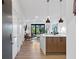 Modern entryway with view of open living area, sleek kitchen and tree views through sliding doors at 112 Rogers Street Northeast Ne St # 410, Atlanta, GA 30317