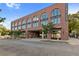 Brick building 'Pullman Flats' with arched windows and covered parking showcasing architectural charm and convenient urban living at 112 Rogers Street Northeast Ne St # 410, Atlanta, GA 30317
