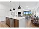 Contemporary kitchen featuring a quartz countertop island, stainless steel appliances, and stylish pendant lighting at 112 Rogers Street Northeast Ne St # 410, Atlanta, GA 30317