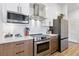 Updated kitchen featuring stainless steel appliances and modern white cabinetry at 112 Rogers Street Northeast Ne St # 410, Atlanta, GA 30317