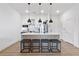 Modern kitchen with island, stainless steel appliances, and stylish pendant lighting at 112 Rogers Street Northeast Ne St # 410, Atlanta, GA 30317