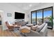 Inviting living room with hardwood floors, large windows, comfortable seating, and natural light at 112 Rogers Street Northeast Ne St # 410, Atlanta, GA 30317