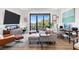 Modern living room with hardwood floors, large windows, comfortable seating, a workspace, and stylish decor at 112 Rogers Street Northeast Ne St # 410, Atlanta, GA 30317