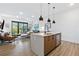 Stylish living area with open floor plan, island, and balcony showcasing modern design at 112 Rogers Street Northeast Ne St # 410, Atlanta, GA 30317