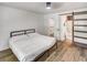 Cozy bedroom with warm hardwood floors, walk-in closet, and sliding glass doors to ensuite bathroom at 2572 Bates Se St, Smyrna, GA 30080