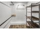 Walk-in closet with modern shelving, wood-look floor, and metal storage racks at 2572 Bates Se St, Smyrna, GA 30080