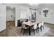 Bright dining room features modern lighting and decor, and a spacious dining table with seating for eight at 2572 Bates Se St, Smyrna, GA 30080