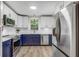 Modern kitchen with white and navy cabinets, stainless steel appliances, and ample storage at 2572 Bates Se St, Smyrna, GA 30080