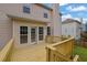 An exterior back deck with wood railings featuring views of backyard and the home's exterior at 2988 Belfaire Lake Dr, Dacula, GA 30019
