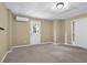 This finished basement includes carpet, AC unit, and exterior door at 2988 Belfaire Lake Dr, Dacula, GA 30019