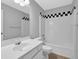 This bathroom has a sink, toilet, and shower and tub combo with white tile surround at 2988 Belfaire Lake Dr, Dacula, GA 30019
