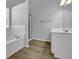 Bathroom with a shower, tub, vanity with wood-look flooring at 2988 Belfaire Lake Dr, Dacula, GA 30019